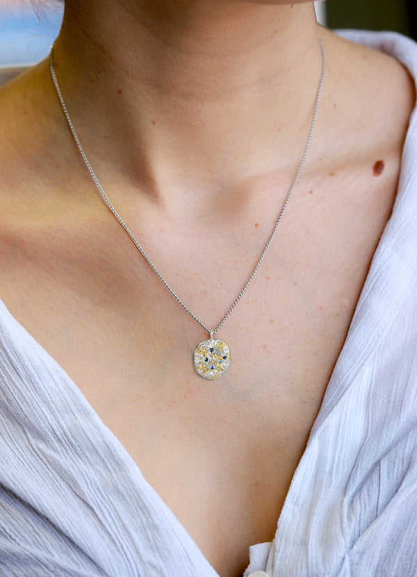 Sapphire Encrusted Round Silver Flux Pendant with Yellow Gold Detail James Newman Jewellery
