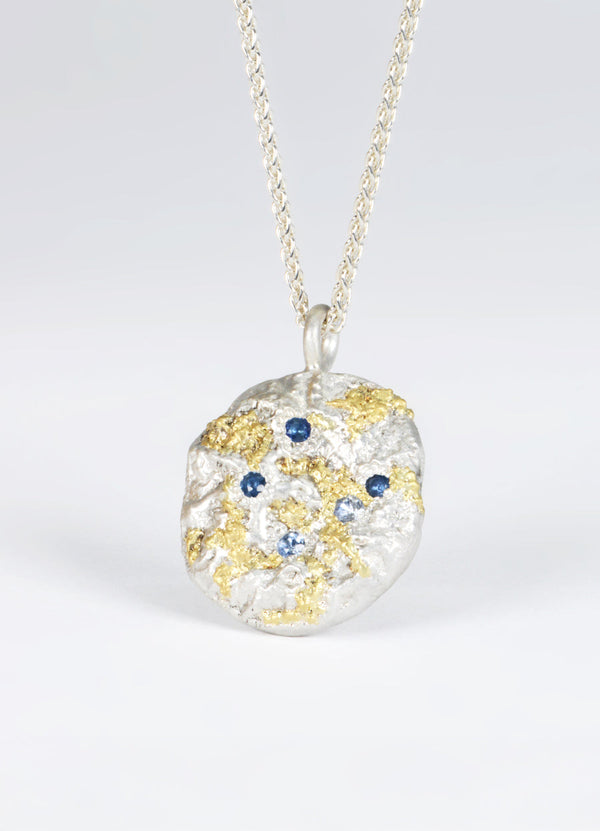 Sapphire Encrusted Round Silver Flux Pendant with Yellow Gold Detail James Newman Jewellery